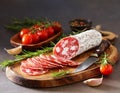 Sliced Ã¢â¬â¹Ã¢â¬â¹salami on a wooden board Royalty Free Stock Photo